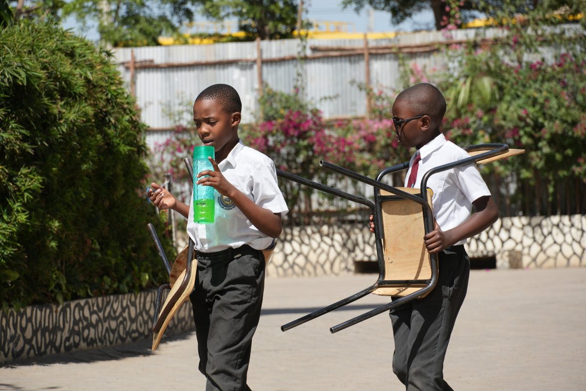 Junior Secondary pupils sitting together in the courtyard