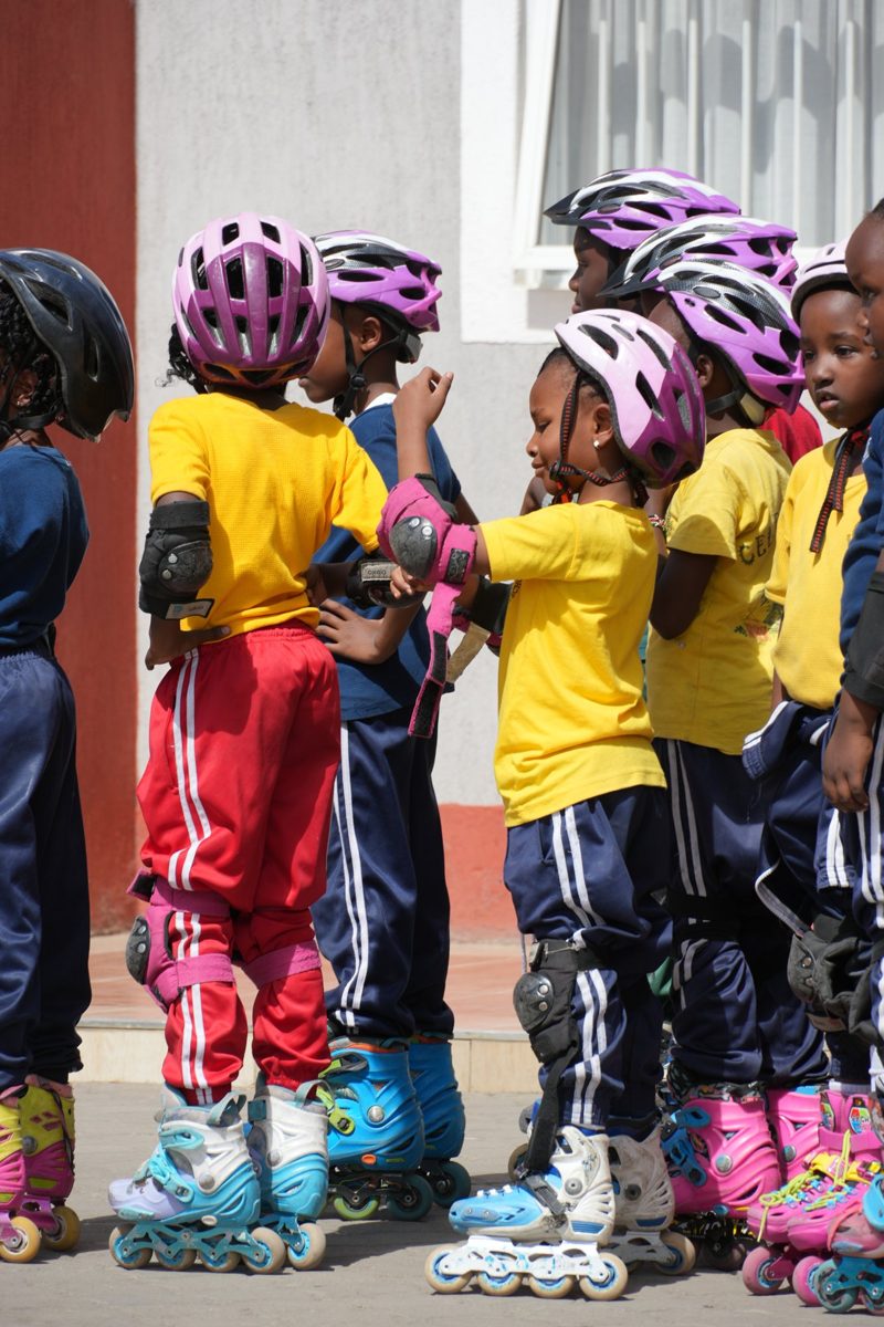 Children in helmets and pads ready for skating