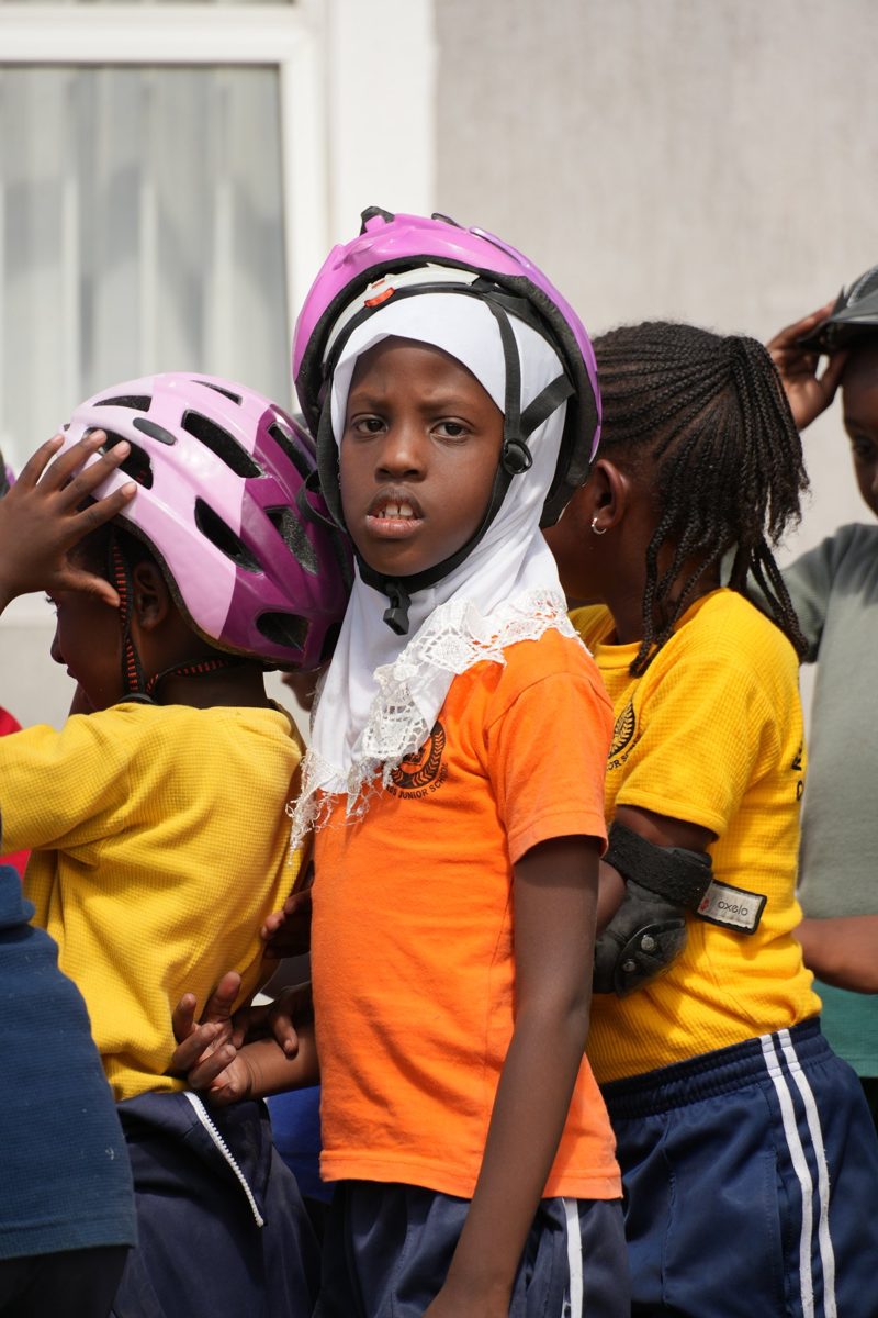 A girl in a pink helmet ready to skate